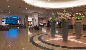 a lobby with three vases with flowers in it at Parkview Hotels & Resorts in Hualien City