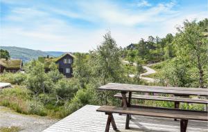 a wooden bench sitting on top of a wooden deck at Lovely Home In seral With Kitchen in Åseral