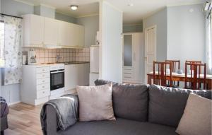 a living room with a couch and a kitchen at Pet Friendly Home In Hassl With Kitchen in Hasslö