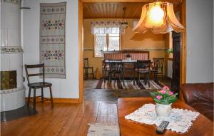 a living room with a table and a dining room at Pet Friendly Home In Mrrum With Kitchen in Mörrum