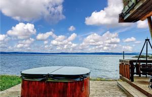 a drum sitting on a dock next to a body of water at Nice Home In Malm With Lake View in Malm