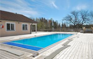 a swimming pool in a yard with a house at 1 Bedroom Beautiful Home In Kosta in Kosta