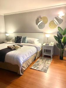 a bedroom with a bed and a table with a plant at Cozy Stylish room in Polanco in Mexico City