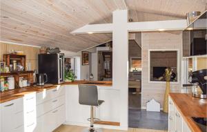 a kitchen with white cabinets and a cross on the wall at Stunning Home In Huskvarna With House A Panoramic View in Huskvarna