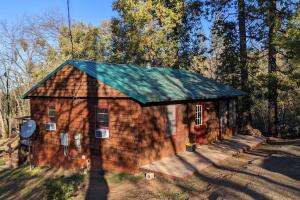 a small house with a green roof at Gilmore Cabin in Miramonte