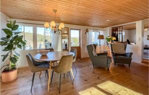 a dining room with a table and chairs at Cozy Home In Sexdrega With Sauna in Sexdrega