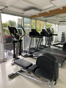 a gym with a row of treadmills and machines at Cozy Stylish room in Polanco in Mexico City
