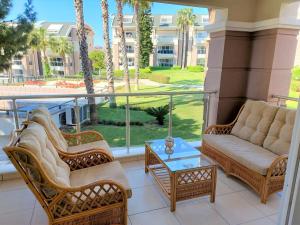 a balcony with two couches and a table at Outstanding 3 Bed Duplex in popular gated community in Side