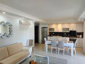 a living room and kitchen with a table and chairs at Outstanding 3 Bed Duplex in popular gated community in Side