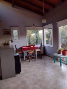 a kitchen and dining room with a table and chairs at Casa de montaña in San Carlos de Bariloche