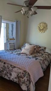 a bedroom with a bed and a window and a fan at The Nook in Dunlap