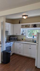 a kitchen with white cabinets and a window at The Nook in Dunlap