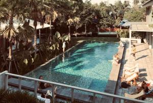 a swimming pool with people in the water at SUNKISS in Bangkok Noi