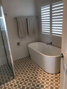 a bathroom with a large tub and a shower at Armara Views in Orange