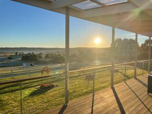 a view of the sunset from the balcony of a house at Armara Views in Orange