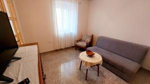 a living room with a couch and a chair at Apartment Nadi - 100 m from sea in Unije