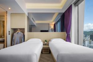 Krevet ili kreveti u jedinici u okviru objekta Starphire Hotel