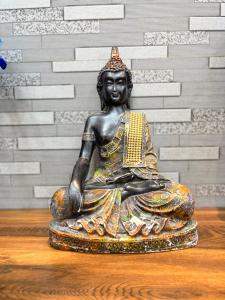 a statue of a woman sitting on a table at Hotel Lemonade in Amritsar