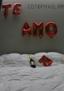 a bed with a sign with the word teddy bear at Cotopaxglam in Latacunga