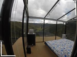 a room with a bed and a view of a mountain at Cotopaxglam in Latacunga
