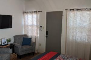 a bedroom with a bed and a chair and a door at Sweet Mountain Cabin in Squaw Valley