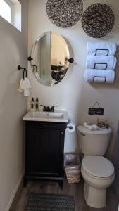 a bathroom with a toilet and a sink and a mirror at Sweet Mountain Cabin in Squaw Valley