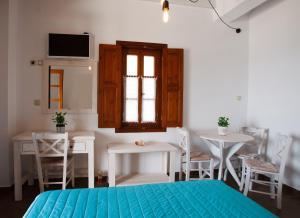a room with a bed and a table and chairs at Mistral-Patmos in Patmos +37 photos