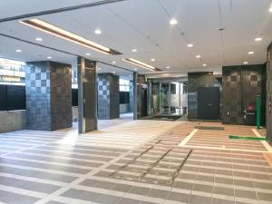 an empty lobby of a building with a tile floor at HOTEL LiVEMAX Shinjuku Kabukicho-Meijidori in Tokyo