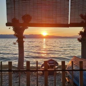 a view of the ocean at sunset from a house at Apartments Krste in Trpejca