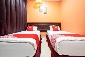 Postel nebo postele na pokoji v ubytování Ipoh Times Inn Hotel + 8 fotografií