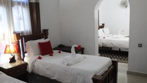 Rúm í herbergi á Al-Minar Hotel