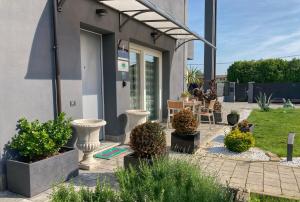 a patio with potted plants in front of a building at Il Viaggiatore B&B in San Giorgio delle Pertiche