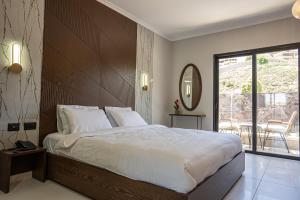 a bedroom with a large bed and a balcony at view hotel in Majdal Shams