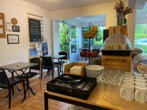 a restaurant with a counter with tables and chairs at Tourhôtel in Béthune +20 photos