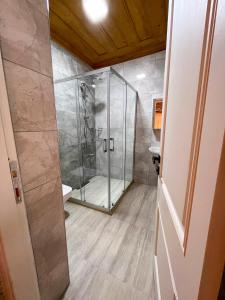 a shower with a glass door in a bathroom at Merlara Otel Alaçatı in Alaçatı +31 photos
