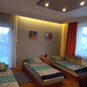 a room with three beds and a window at Hostel Słodki Sen in Lublin