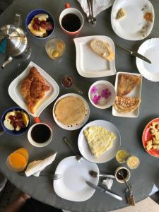 a table topped with plates of food on top at Easy Stay Residence in Trou aux Biches