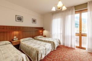 Postel nebo postele na pokoji v ubytování Albergo Belvedere