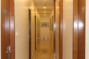 a hallway with a long corridor with wooden doors at Hotel Airside in Mumbai