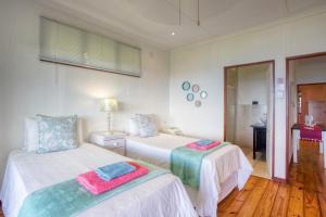 a bedroom with two beds with towels on them at Mar Azul 21 in Ponta Malongane