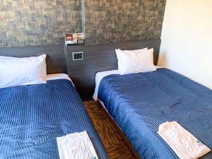 Postel nebo postele na pokoji v ubytování HOTEL LiVEMAX Shinjuku Kabukicho