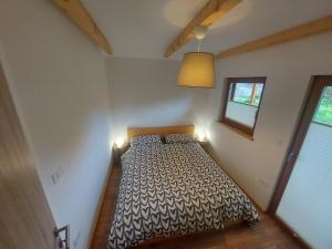 a bedroom with a bed with two lights on it at Apartma Mataj in Kobarid