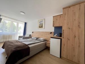 ein Schlafzimmer mit einem Bett und einer Holzwand in der Unterkunft Willa Amelia in Solina