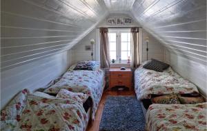 a attic room with two beds and a window at Amazing Home In Bygland With 2 Bedrooms in Bygland