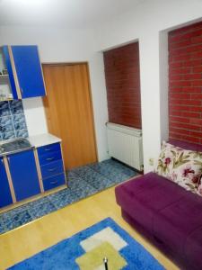 a living room with a couch and a brick wall at Apartman Centar in Foča