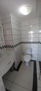 Un baño blanco con inodoro y lavabo. en Seagull 304, en Margate 13 fotos más