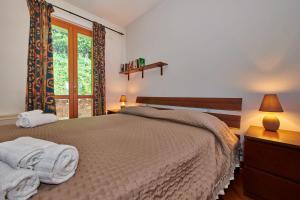 a bedroom with a bed with towels on it at ApartmentsGarda - Baia D'Argento Residence in Costermano +17 photos