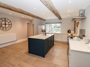 a kitchen with a large island in the middle at Ley Mill Farm in Westbury on Severn