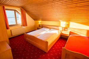 a bedroom with a large bed in a room at Hotel Weissenstein in Sankt Michael im Lungau