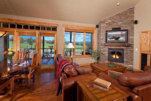 a living room with a couch and a fireplace at Brasada Ranch in Powell Butte